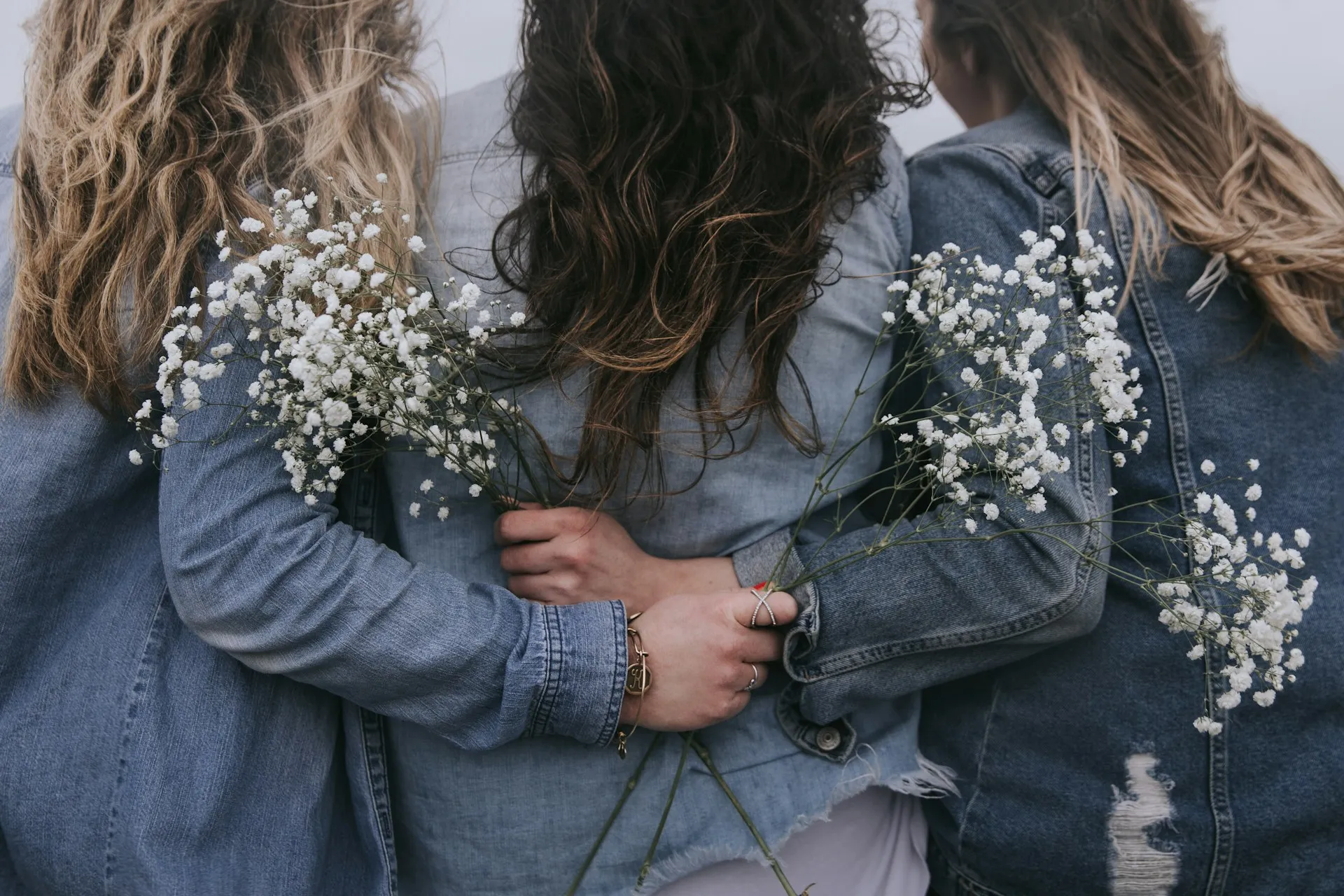 Friends embracing with flowers